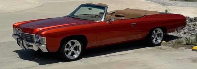 Custom red convertible classic car build showcasing expert bodywork, paint, and craftsmanship